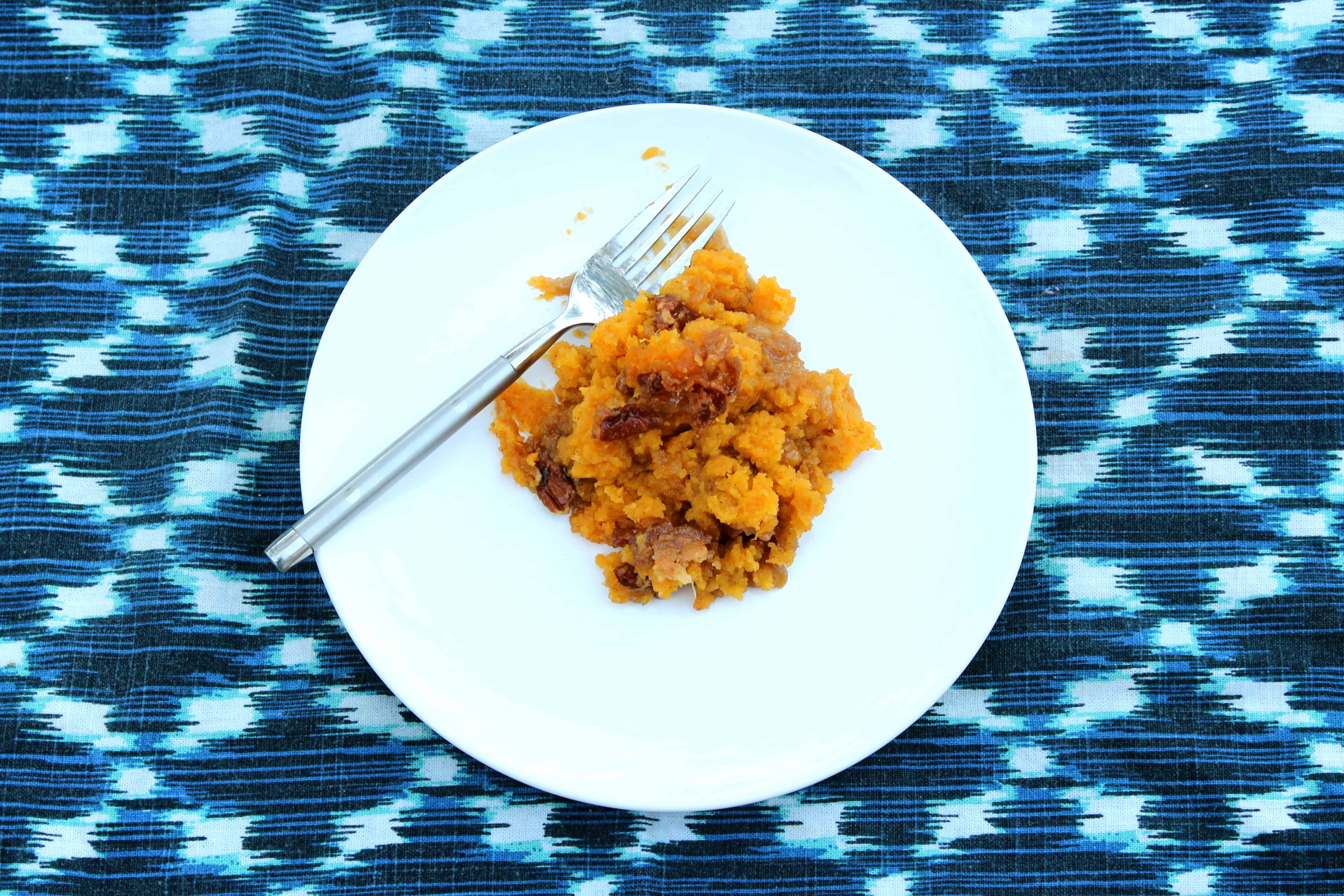 bright colored placemat with white plate, serving of sweet potato casserole, photo taken from above