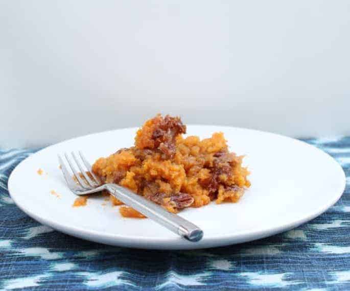 plate with a serving of sweet potato casserole with fork